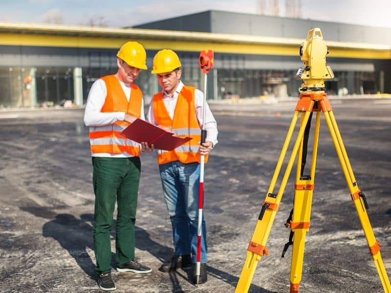 Land surveyors conducting an ALTA land title survey at a commercial property in Chicago, IL