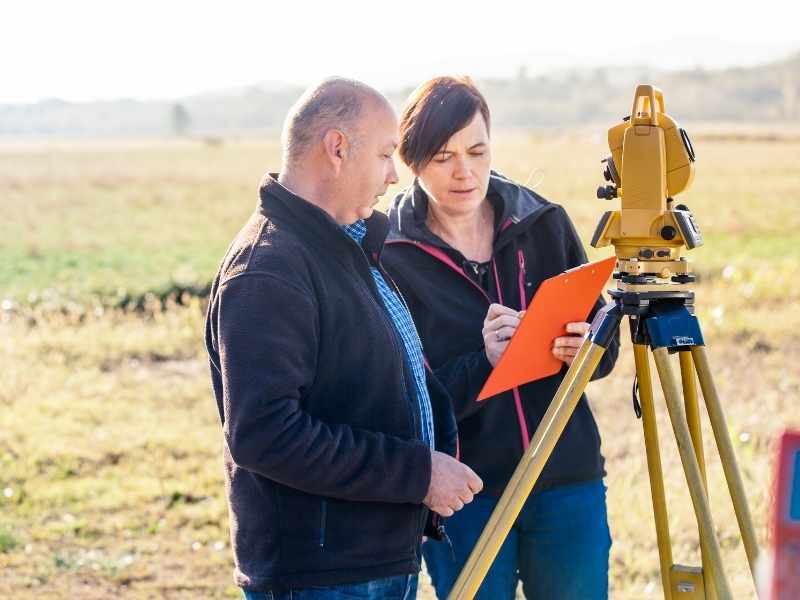 Licensed land surveyor reviewing fieldwork and surveying equipment in Chicago, Illinois.

